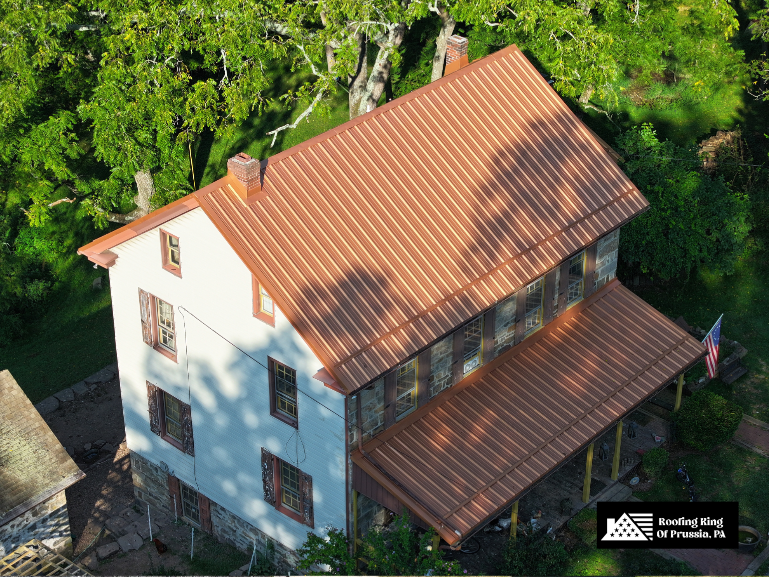 Traditional home with stylish copper-colored metal roofing.