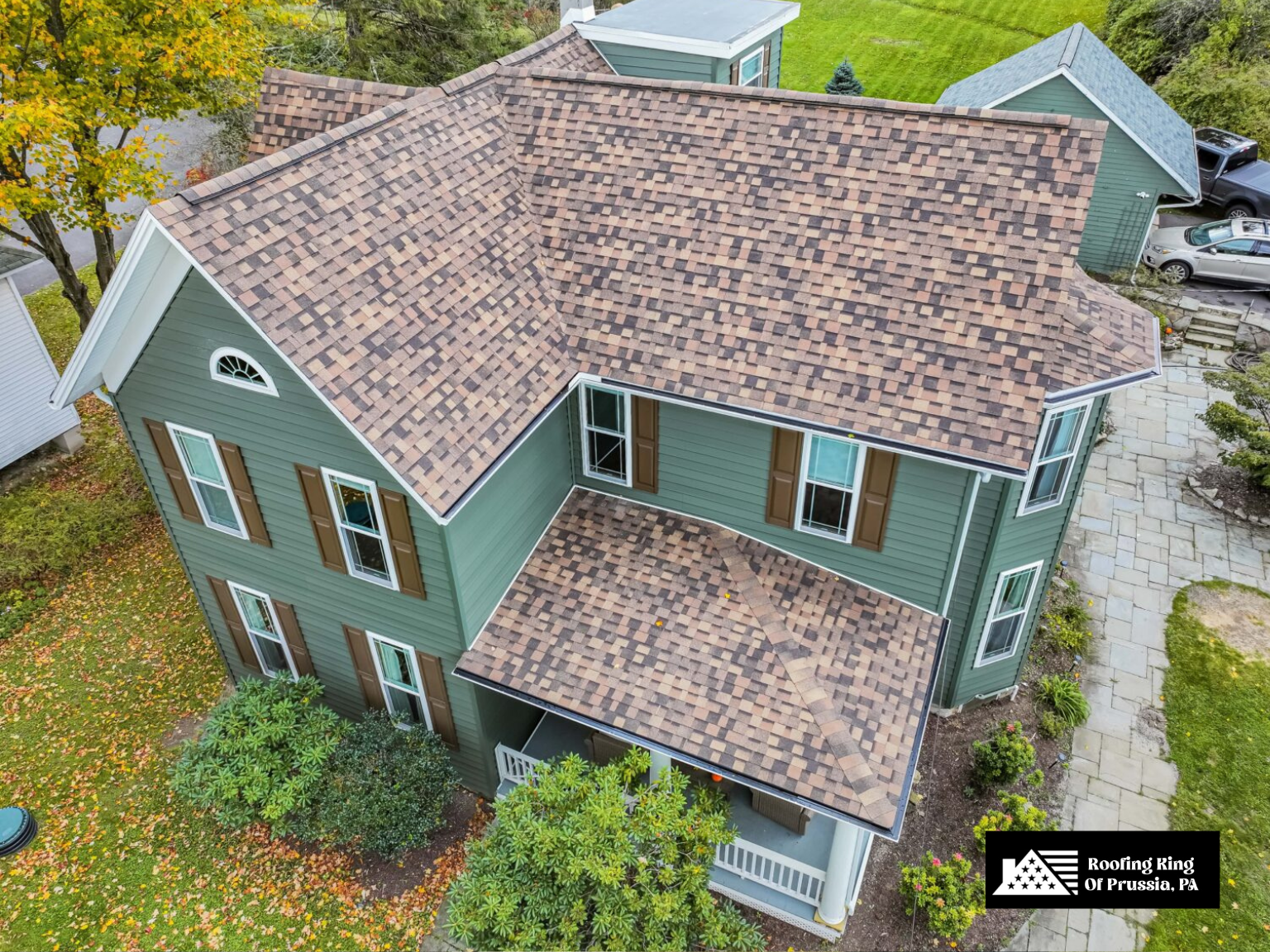 Classic home with a multi-colored asphalt shingle roof installation.